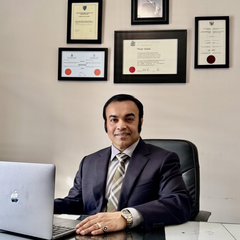 Nizam Hashmi, Barrister and Solicitor, at his office